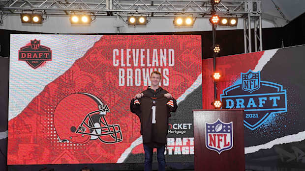 Apr 29, 2021; Cleveland, Ohio, USA; A Cleveland Browns fan poses with No. 1 jersey at the Draft Stage exhibit at the NFL Draft Experience at First Energy Stadium. Mandatory Credit: Kirby Lee-USA TODAY Sports